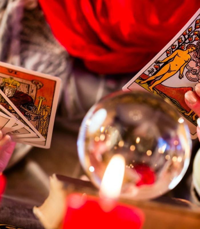 Female Fortuneteller or esoteric Oracle, sees in the future by playing her tarot cards during a Seance to interpret them and to answer questions